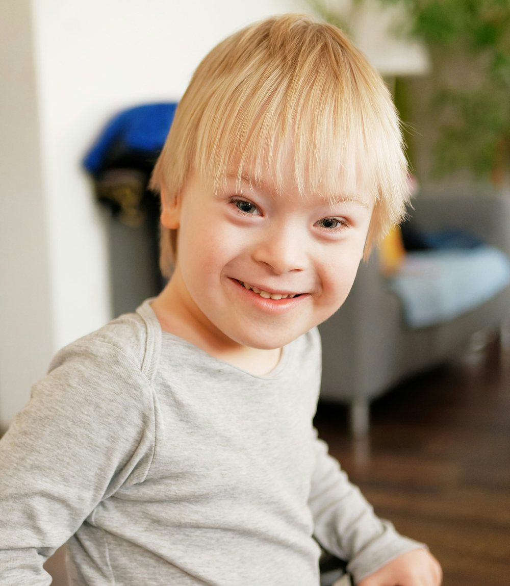 A smiling young boy taking part in an inclusive learning session